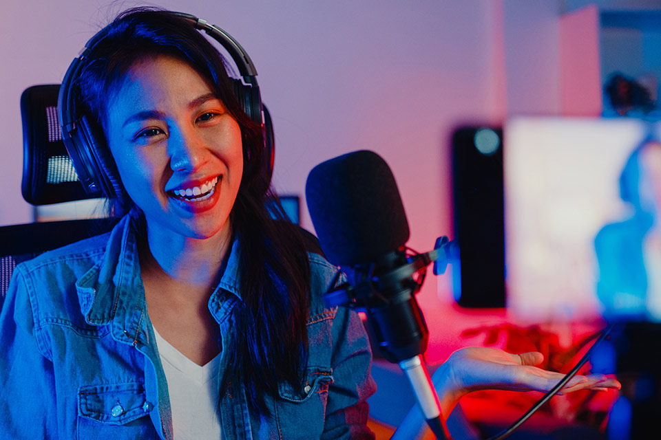 Woman engaging in live streaming marketing in front of a mic