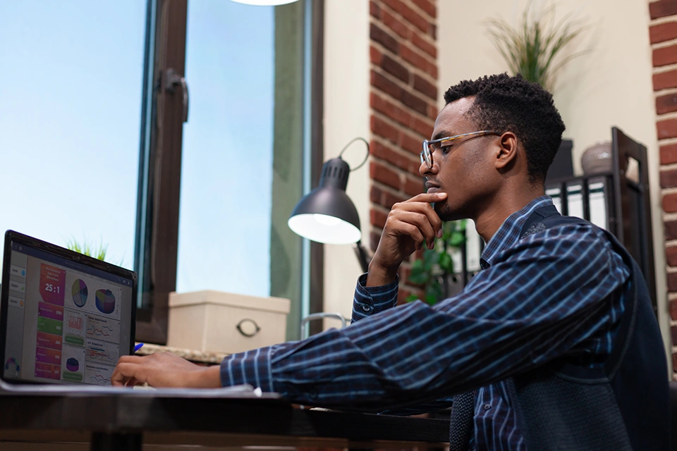 Man at a laptop experiencing the challenges of influencer marketing management