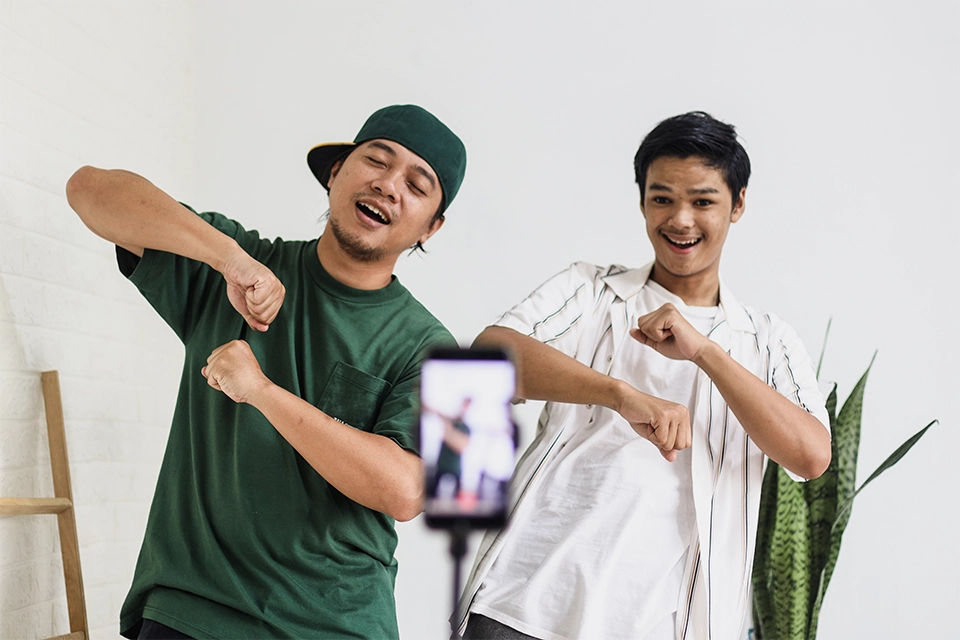 Two dancers recording a video for one of many Instagram reel trends