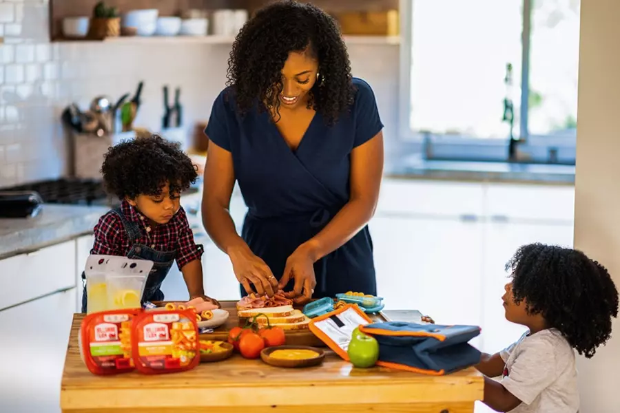 A mom influencer making sandwiches with her two kids