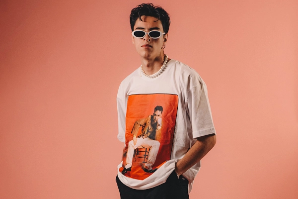 Gen Z fashion influencer in a t-shirt, pearls, and sunglasses